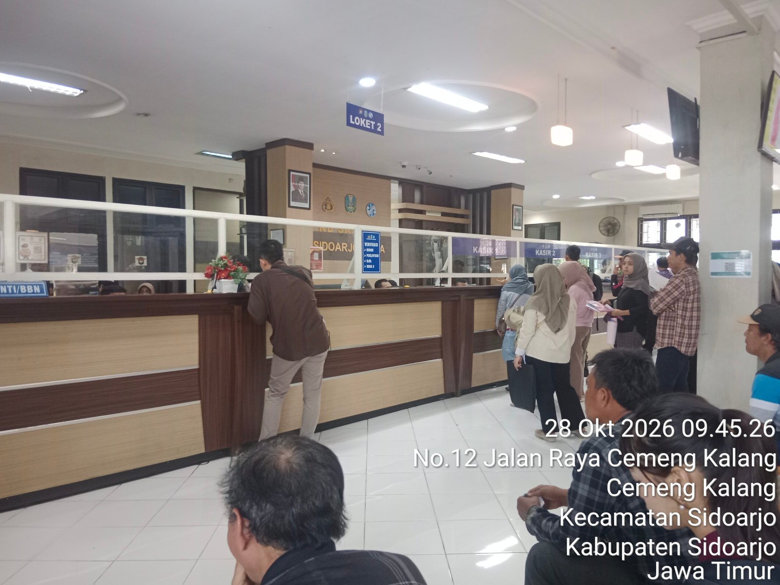 Pelayanan Samsat Sidoarjo Terlihat Berjalan Dengan Lancar, Warga Antre di Loket untuk Mengurus Administrasi Kendaraan Pelayanan Samsat Sidoarjo Terlihat Berjalan Dengan Lancar, Warga Antre di Loket untuk Mengurus Administrasi Kendaraan